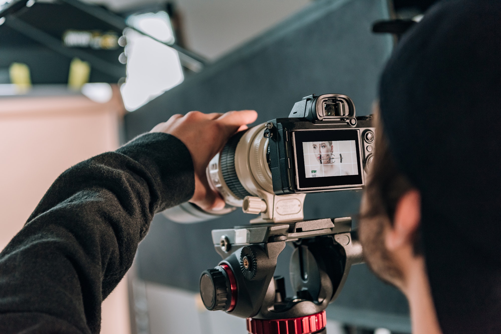 selective-focus-of-videographer-filming-woman-in-photo-studio.jpg
